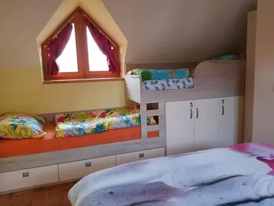 a bedroom with two bunk beds and a window at TULPIKA 13 in Moravske Toplice