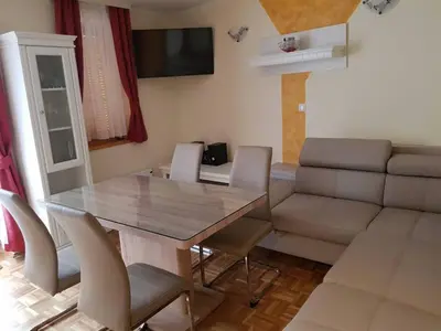 a living room with a table and a couch at TULPIKA 13 in Moravske Toplice
