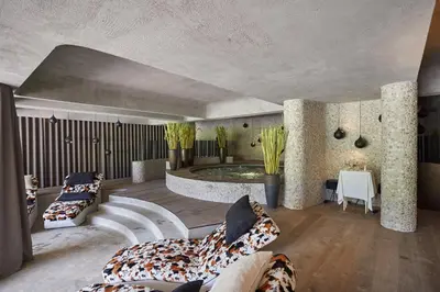 a living room with two couches and a pool at Hotel Plesnik Logar Valley in Solčava