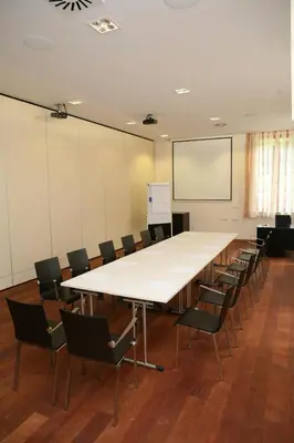 a large conference room with a large table and chairs at Hotel Plesnik Logar Valley in Solčava
