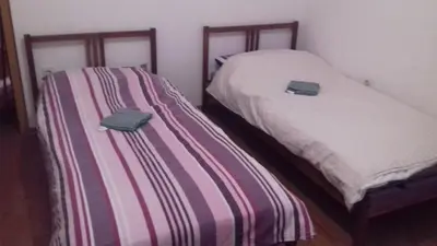 two beds sitting next to each other in a room at Apartment Green Valley in Idrsko