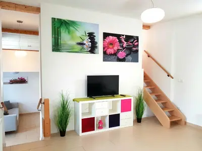a living room with a tv on a cabinet at Sky in Bled