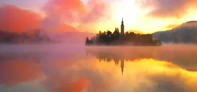 a church on a island in the middle of a lake at Sky in Bled