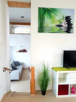 a living room with a couch and a table at Sky in Bled