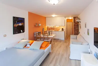 a living room with two beds and a kitchen at Chic Cosy Quiet in Ljubljana Center in Ljubljana
