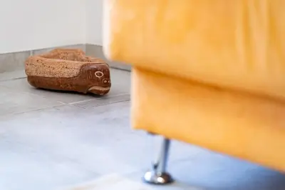 a wooden block sitting on the floor next to a dresser at Apartments and rooms Nataša 2 in Trenta
