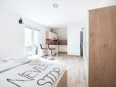 a white room with a bed and a table at Apartments and rooms Nataša 2 in Trenta