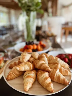 a plate of croissants and other pastries on a table at Tri lučke Hotel & Restaurant in Krško