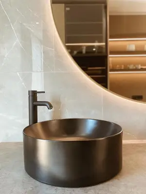a bronze sink in a bathroom with a mirror at Tri lučke Hotel & Restaurant in Krško