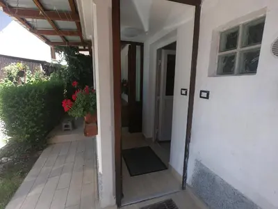 an open door to a house with a porch at Fontana in Bovec
