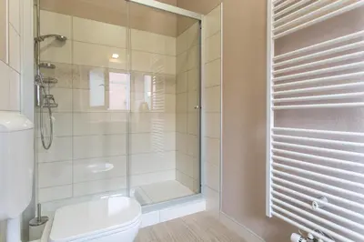 a bathroom with a toilet and a glass shower at Rohrmann apartments in Ljubljana