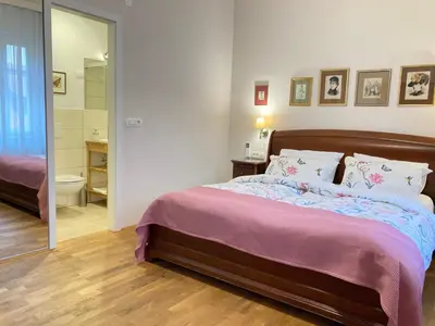 a bedroom with a bed and a bathroom at Rohrmann apartments in Ljubljana