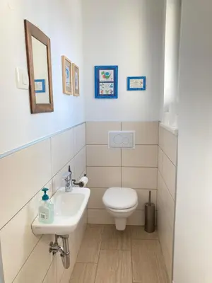 a bathroom with a toilet and a sink at Rohrmann apartments in Ljubljana