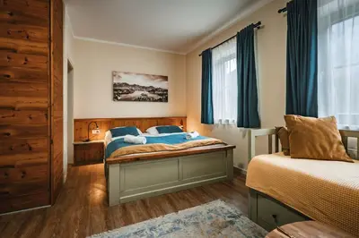 a bedroom with two beds and a window at Guest House EJGA in Jesenice