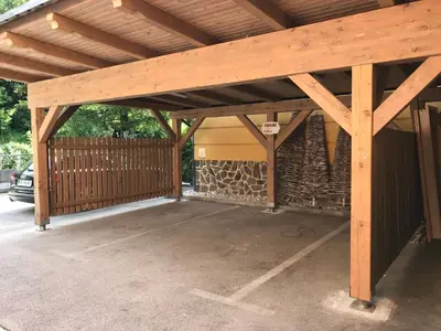 a wooden pavilion with a fence and a building at Guest House EJGA in Jesenice