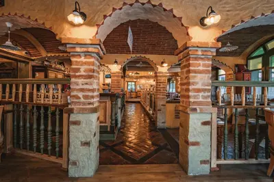 a library with arches and books on the walls at Guest House EJGA in Jesenice