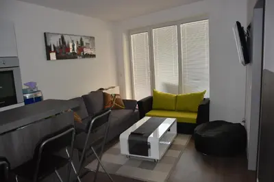 a living room with a couch and a tv at Apartment Velcom in Moravske Toplice