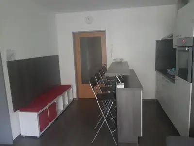 a room with a kitchen with chairs and a counter at Apartment Velcom in Moravske Toplice