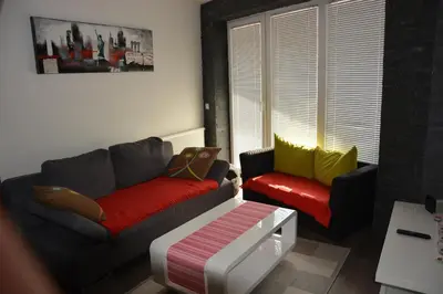 a living room with two couches and a table at Apartment Velcom in Moravske Toplice