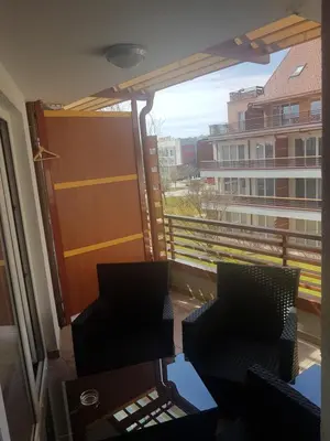 a balcony with two chairs and a view of a building at Apartment Velcom in Moravske Toplice