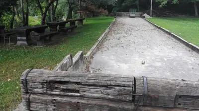 a row of benches in a park with grass at Domačija Bubec in Ilirska Bistrica