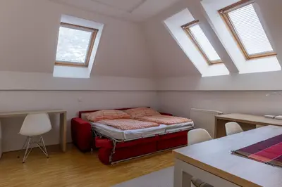 a bedroom with a bed in a room with skylights at Bled4U Apartment in Bled