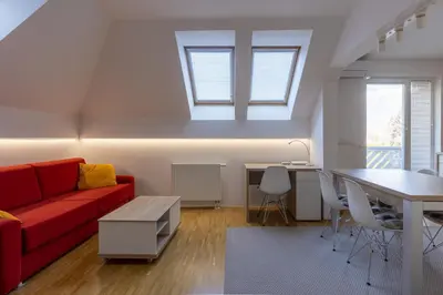 a living room with a red couch and a table at Bled4U Apartment in Bled