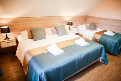 a bedroom with two beds with towels on them at Guest House Vila Moj Mir in Rateče