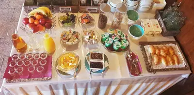 a table topped with different types of food and desserts at Guest House Vila Moj Mir in Rateče