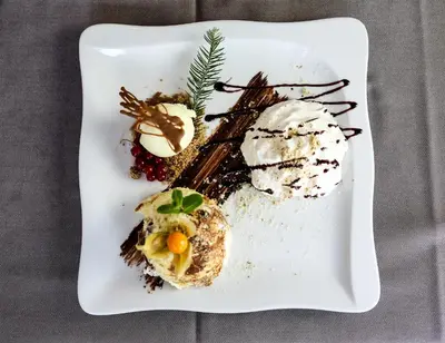 a plate of food with ice cream and desserts at Guest House Vila Moj Mir in Rateče