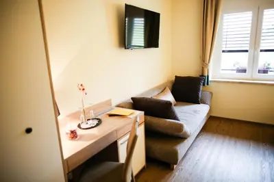 a living room with a couch and a table at Guest House Vila Moj Mir in Rateče