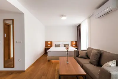 a living room with a bed and a couch at Hotel Ajdovec in Sevnica