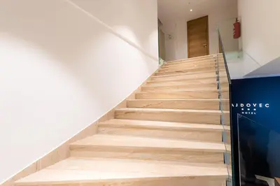 a staircase in a building with wooden floors at Hotel Ajdovec in Sevnica