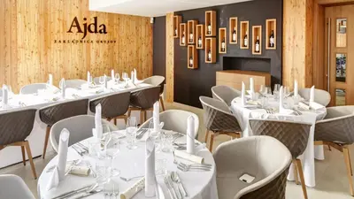 a row of tables and chairs in a restaurant at Hotel Ajdovec in Sevnica