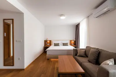 a hotel room with a bed and a couch at Hotel Ajdovec in Sevnica