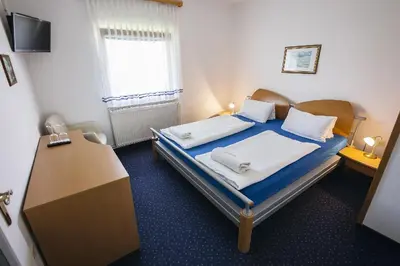 a small bedroom with a bed and a desk at Prenočišče Šinkec Nada in Moravske Toplice