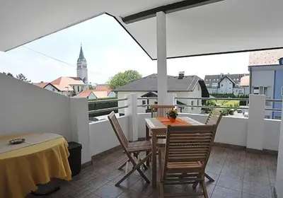 a patio with a table and chairs on a balcony at Prenočišče Šinkec Nada in Moravske Toplice