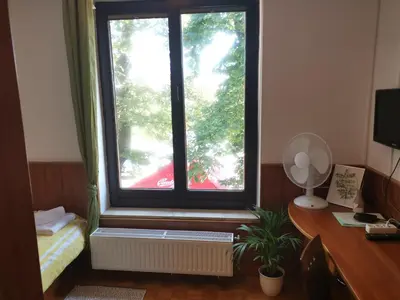 a window in a room with a desk and a desk at Guest House Park Žibert in Ljubljana