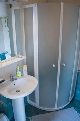 a bathroom with a sink and a shower at Guest House Park Žibert in Ljubljana