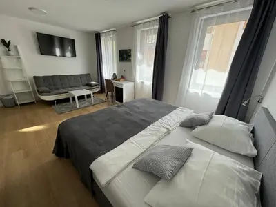 a bedroom with a large bed and a couch at Gostisce Sovdat in Bovec