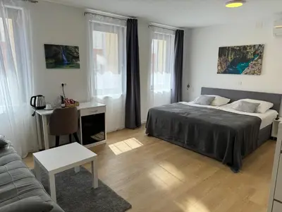 a bedroom with a bed and a desk and a couch at Gostisce Sovdat in Bovec