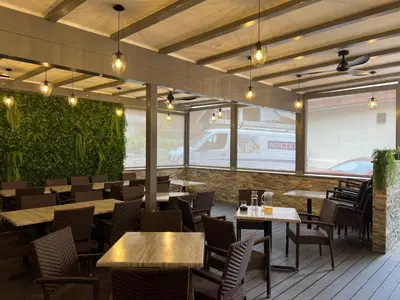 a restaurant with tables and chairs and windows at Gostisce Sovdat in Bovec