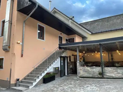 a building with a staircase next to a building at Gostisce Sovdat in Bovec