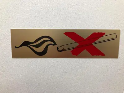 a sign with a pair of chopsticks and a smoking symbol at Guesthouse GreenSLO in Ljubljana