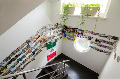 a staircase with lots of pictures on the wall at Guesthouse GreenSLO in Ljubljana
