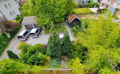 an aerial view of two cars parked in a yard at Guesthouse GreenSLO in Ljubljana