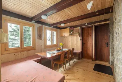 a dining room with a wooden table and chairs at Chalet Gorenjka - Velika planina in Stahovica