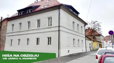 a white building on the side of a street at Bajta na obzidju in Maribor
