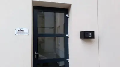 a door to a building with a sign on it at Bajta na obzidju in Maribor