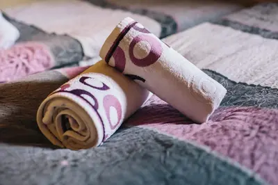 a roll of toilet paper sitting on a bed at Holiday house Jereka -Bohinj in Bohinj